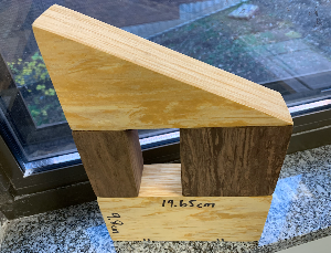 The depth of all solids shown here = 4.5 cm. Shorter leg of the right triangle (up top) = 9.8 cm. Each side of the square (right) = 9.8 cm. The space in the middle is congruent to the prism to its left.
